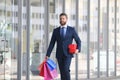 Rich man. Business man shopping in a shopping center. Happy businessman in suit holding paperbags. Shopaholic man Royalty Free Stock Photo