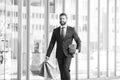 Rich man. Business man shopping in a shopping center. Happy businessman in suit holding paperbags. Shopaholic man Royalty Free Stock Photo