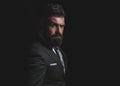 Rich man model. Business man concept. Businessman in dark grey suit with long beard. Man in classic suit, shirt and tie.