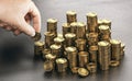 Rich man stacking golden money coins. Income saving plan