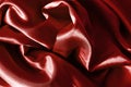 Rich matte red satin folded fabric texture. Abstract background for design