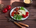 Rich omelette breakfast with grilled sausage and fresh tomatoes and a cup of coffee with milk on a wooden tray Royalty Free Stock Photo