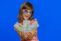 Rich pleased girl child kid waving money dollar cash bills, success, lottery winner, income, wealth Royalty Free Stock Photo