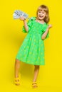 Rich pleased girl child kid waving money dollar cash bills, success, lottery winner, income, wealth Royalty Free Stock Photo