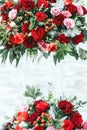 Rich red bouquets of roses, peonies and ranunculus in the glass