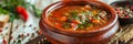 Rich Rustic Soup in Clay Pot, Hot Beef Broth, Meat Bouillon with Greenery Spices in Ceramic Cookware