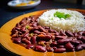 Rich and savory close-up of red beans and rice with steam rising from the plate and colorful spices on top
