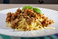 Rich spicy Italian spaghetti Bolognaise with parmesan cheese and a fresh green basil leaves viewed from overhead on a Royalty Free Stock Photo