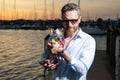 Rich stylish business man dreaming and thinking near the yacht. Portrait of confident man in yacht club. Stylish Royalty Free Stock Photo