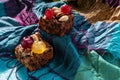 Rich sweet Christmas puddings loaded with dry fruits, nuts and spices on vibrant eastern background Royalty Free Stock Photo