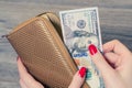 Rich woman taking from purse money Royalty Free Stock Photo