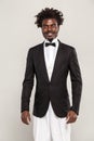 Richly african gentelman in tuxedo and bow of tie smiling Royalty Free Stock Photo