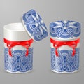 Richly decorated with blue lace pattern round gift boxes. Cylindrical cardboard or metal containers with a red ribbon and a bow. Royalty Free Stock Photo