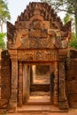 Richly decorated entrance door of Temple Banteay Srei, Cambodia. Carvings from Hindu mythology on walls Banteay Srei, Angkor Wat.