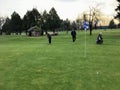 A father and son playing golf, putting for pars, on a cold winter day on Christmas Eve in Richmond, British Columbia, Canada.