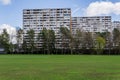 RICHMOND, CANADA - MARCH 31, 2020: Springtime view of big green field in front of huge apartment buildings complex