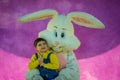 Richmond, KY US - March, 31 2018 - Easter Eggstravaganza - A boy poses with an Easter Bunny character for a photo,