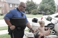 Richmond, Ky US - September 9th, 2017 - Kid's Fest A motorcycle officer holds a small girl's hand