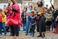 A powerful black female leader wears a Black Lives Matter PPE face mask stands next to her Superhero son at a BLM protest in