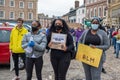 Three black girls wearing face masks hold banners at a Black Lives Matter protest in Richmond, North Yorkshirepr Royalty Free Stock Photo