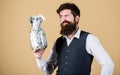 Richness and wellbeing. Security and cash money savings. Banking concept. Man bearded guy hold jar full of cash savings Royalty Free Stock Photo