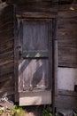 Rickety old barn with wooden door broken