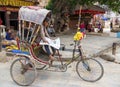 Rickshaw driver reading newspaper in Kathmandu