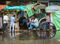 A rickshaw driver waiting for passengers on street in Kolkata, India