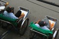 Rickshaw drivers in a street in Hoi An (Vietnam) Royalty Free Stock Photo