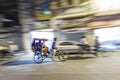 rickshaw driving in blurred motion by night in Chandni Chowk. The Chandni Chowk is one of the oldest and busiest markets in Old Royalty Free Stock Photo