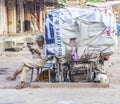 Rickshaw man rests and reads news