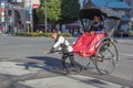 Rickshaw-puller with a couple tourists in Asakusa district Royalty Free Stock Photo