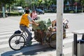 Rickshaw rider transports trash for recycling in his cycle rickshaw