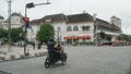 The rickshaw stops at a traffic light with a post office building in the background Royalty Free Stock Photo