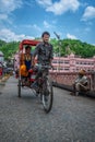 Rickshaw wala pulling pilgrims visiting Haridwar Royalty Free Stock Photo