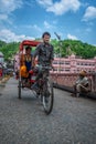 Rickshaw wala pulling pilgrims visiting Haridwar