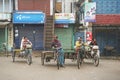 rickshaws wait for passengers in Puthia, Bangladesh.