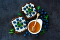 Ricotta, blueberries and honey sandwiches Royalty Free Stock Photo