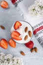 Ricotta dessert with fresh strawberries. Healthy breakfast of yogurt, strawberry and almonds Royalty Free Stock Photo