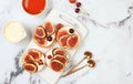 Ricotta,figs and bruschetta with honey on gray marble.Fresh sandwiches and toast with cream cheese,sliced figs,honey and cherries. Royalty Free Stock Photo