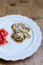 Ricotta pancakes with parmesan cheese and tomatoes salad on plate over wooden background