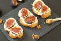 Ricotta sandwiches, fresh figs, walnuts and honey on a slate plate
