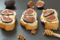 Ricotta sandwiches, fresh figs, walnuts and honey on a slate plate