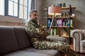 Rid the world of pain. Sad middle aged military man looking away, sitting on the couch during therapy session. Soldier Royalty Free Stock Photo