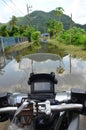 Ridding motorcycle in a flood in Thailand.