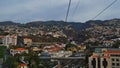 Ride in the cable car in Funchal, Madeira, Portugal with view over the city with highway, buildings and mountains. Royalty Free Stock Photo