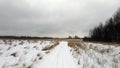 An SUV paves its way in a snowy field. Travel in winter by car