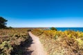 Ride on the GR34 in Brittany with far off Cape Frehel and its lighthouse Royalty Free Stock Photo