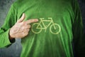 Ride your bike. Man pointing to bicycle insignia printed on his