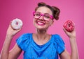 Rident woman showing sprinkled doughnuts Royalty Free Stock Photo